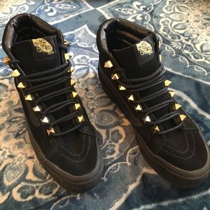 All black vans w/ gold embellishments